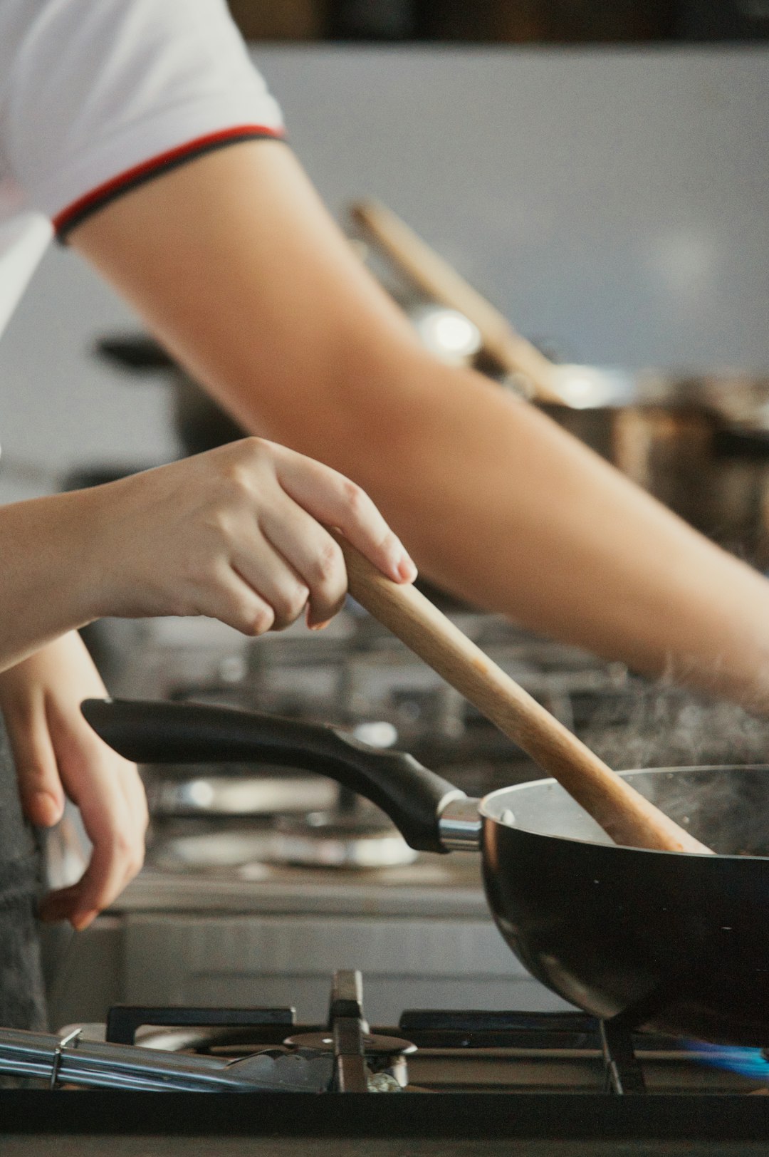 Student cooking a meal in a shared kitchen
