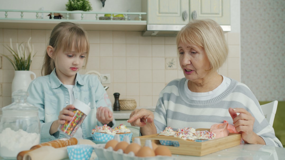 Host grandmother and child baking together in a family kitchen